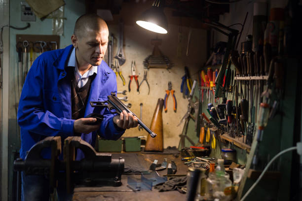istock Gun repairman disassembling sporting handgun before preventive maintenance 1294826007