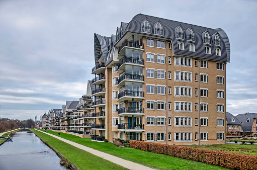 Voorschoten, The Netherlands, January 3, 2021: eight-storey residential building in Krimwijk neighbourhood with brick facades and sculptural roof in post-modern style