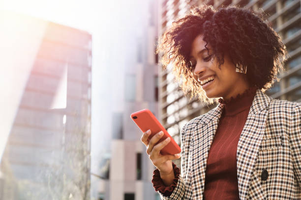 istock Business woman smiling and using mobile phone. 1294830433