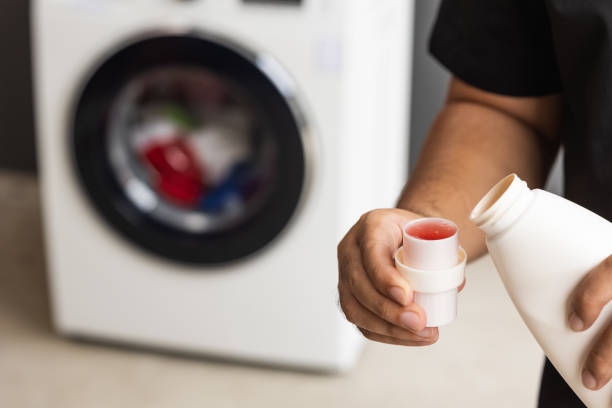istock Pour some laundry detergent on the clothes and put it in the washing machine 1294830445