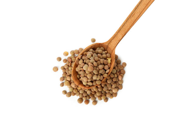 istock Wooden spoon with legumes isolated on white background 1294831123
