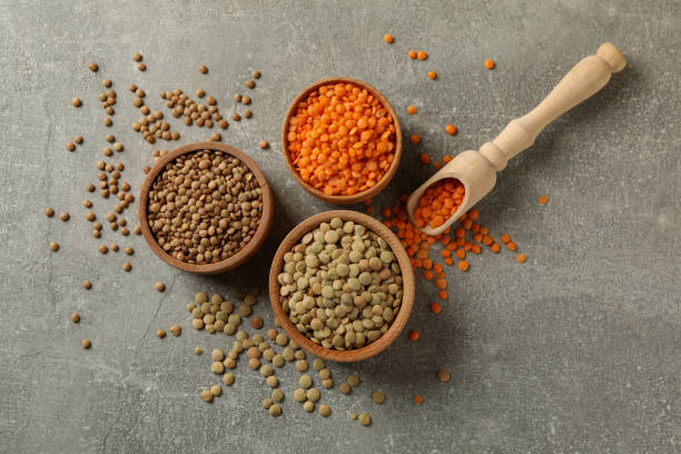 istock Scoop and bowls with different legumes on gray background 1294831870