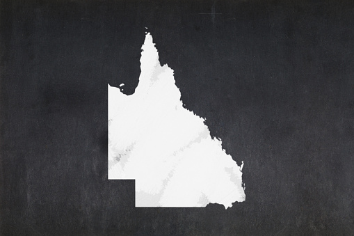 Blackboard with a the map of the State of Queensland (Australia) drawn in the middle.