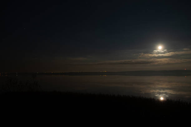 istock Full moon and cloudy sky reflection in the lake 1294833644