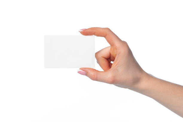 istock Female hand with blank white business card isolated on white 1294833822
