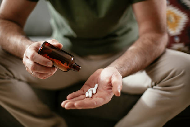 istock Close up of man hands holding pill. 1294835785