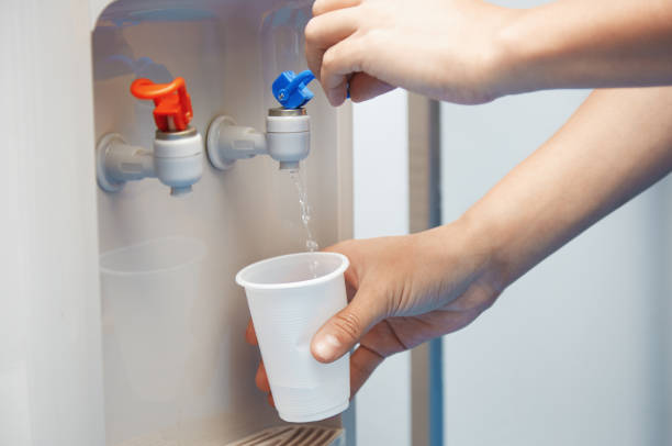 Gallon bottled drinking water in a dark room, helps remind the importance of drinking a lot avoiding dehydration and helps the mind focus more.