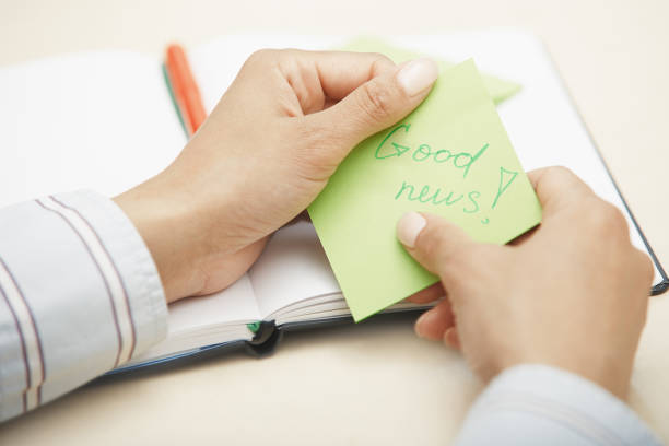 istock Woman holding sticky note with Good news text 1294844609
