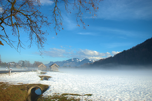 Walking in the snow covered countryside in Ruggell in Liechtenstein December 17,2020