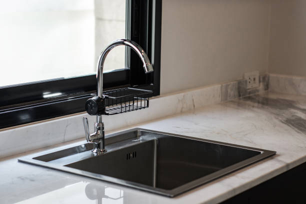 istock Close up of modern kitchen faucet and sink 1294847986