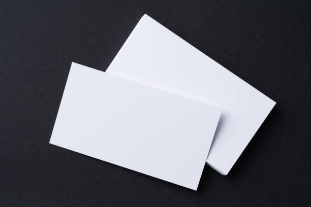 istock White blank business cards on dark black background 1294849098