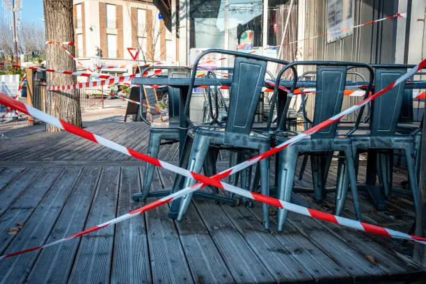 french terrace cafe closed and taped off to stop people sitting on the terrace because of coronavirus shutdown ,covid 19 .