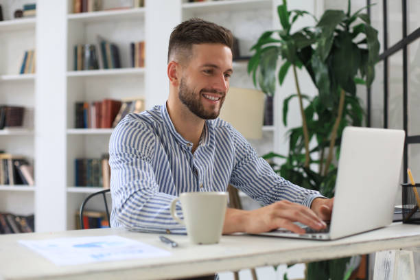 istock Happy young business man is analizing financial documents from home during self isolation. 1294853828