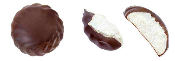 istock Chocolate coated marshmallow (zefir) isolated on white background. Sweet Round marshmallow with pieces closeup. Top view