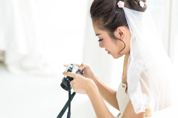 istock Thai Bride looking pictures from camera 1294863950