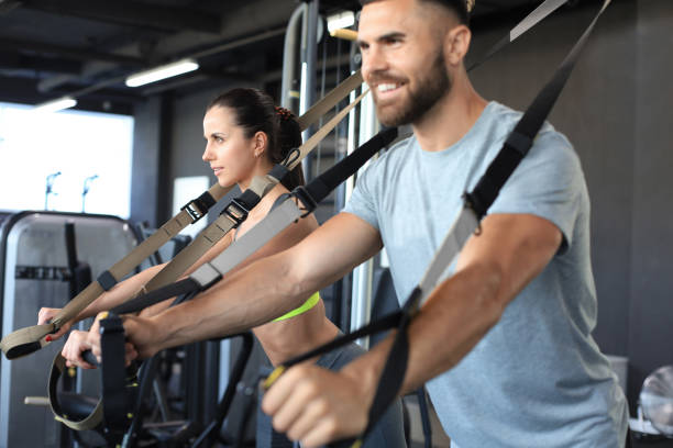 istock Young couple on body training with trx in gym. 1294866215