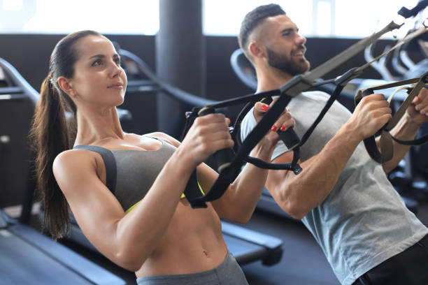 istock Young couple on body training with trx in gym. 1294866318