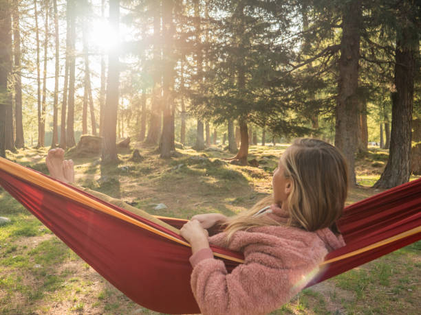 istock Woman relaxes in hammock at sunset 1294866741