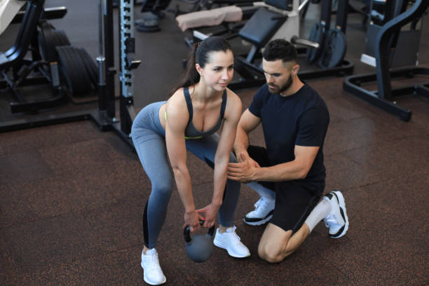 istock Fitness instructor exercising with his client at the gym. 1294866791