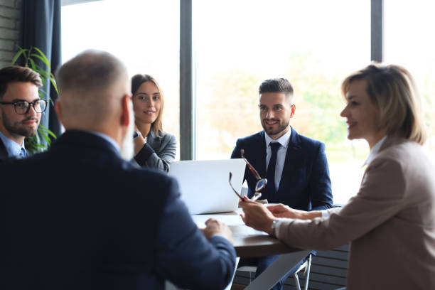 istock Team of business people having discussion at table in creative office. 1294867050