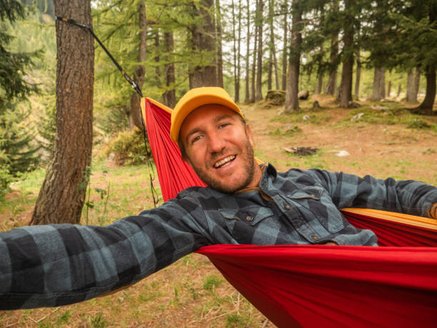 istock Selfie- Man relaxes in hammock 1294867289