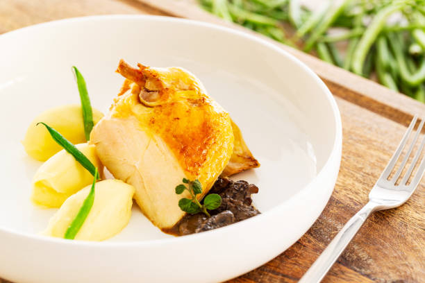 istock Roasted chicken breast with mashed potatoes, green beans and mushroom sauce aside a fork and some natural green beans. 1294869576