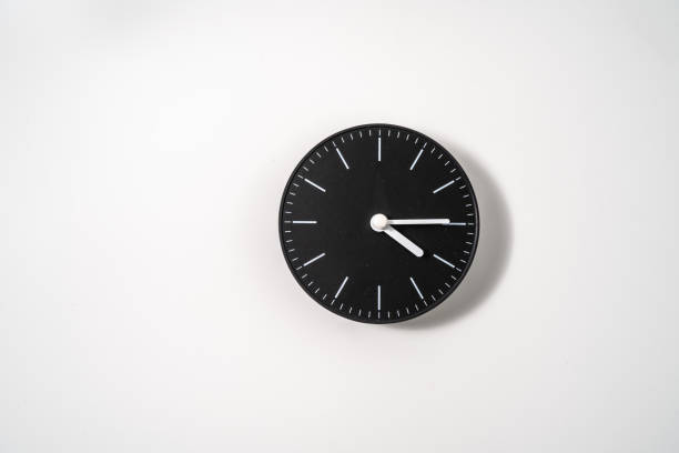 istock close up of an office clock on white background with clipping path 1294873615