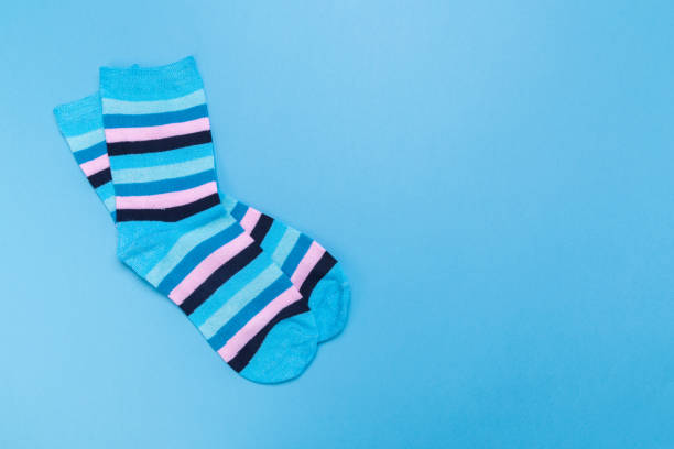 istock blue new socks stacked on a blue background. top view. place for text. 1294875447