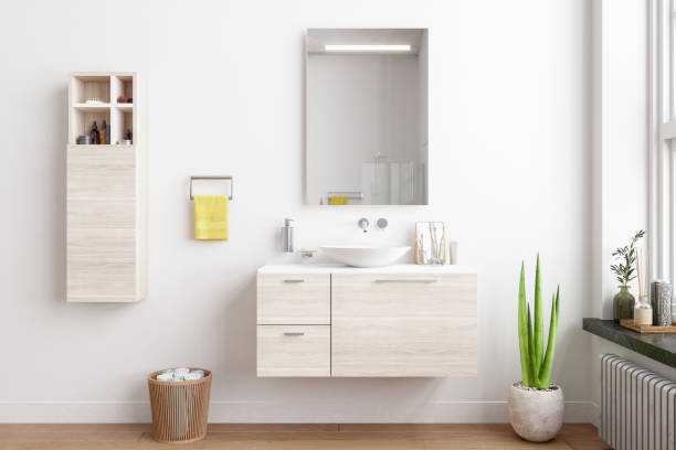 salle de bains moderne avec armoires en bois, miroir, plante en pot, et une serviette jaune. - wall mirror photos et images de collection