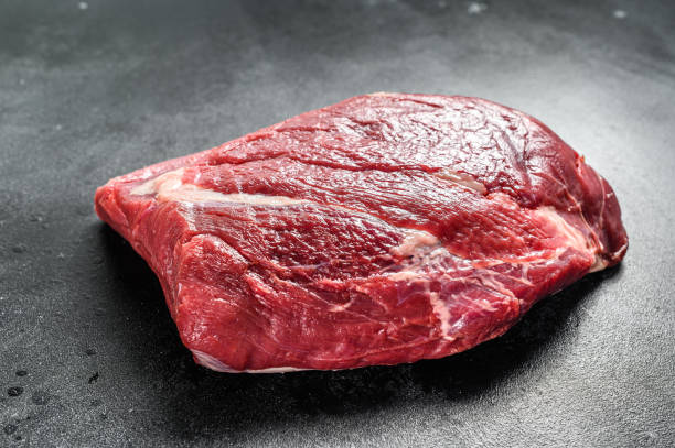 istock Raw Round beef cut. Black background. Top view 1294876851