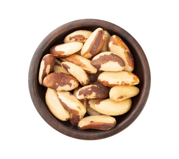 istock Brazil nuts on a plate isolated over white background 1294878636