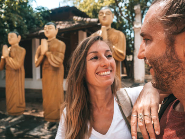 istock Couple contemplate buddha statues in ancient temple 1294882331