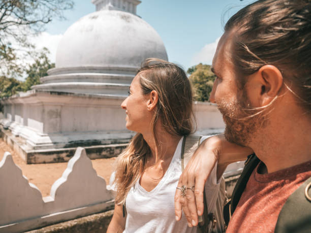 Couple contemplate white dome temple