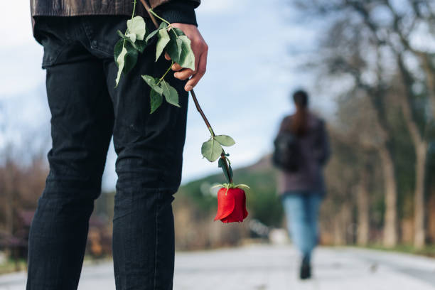 istock Young man with a red rose in his hand after breakup 1294883124