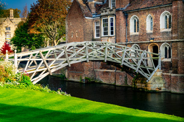Cambridge, UK, Jan 7, 2022. View of a boat with visitors near the Mathematical Bridge at Cambridge university in a sunny day.