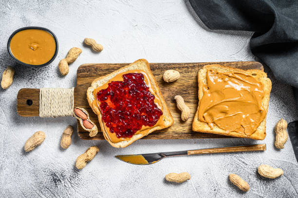 istock Peanut butter sandwich  toast with berry jam.  White background. Top view 1294884980