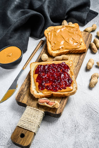 istock Peanut butter sandwich  toast with berry jam.  White background. Top view 1294884999