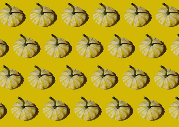 istock Creative colorful vegetable pattern of yellow squash patisson on yellow background. Harvest concept. 1294885058
