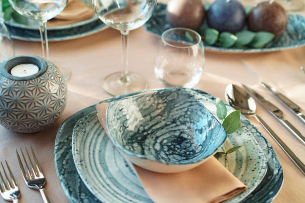 istock Beautiful elegant table setting with green stylish dishware and silver cutlery 1294886223