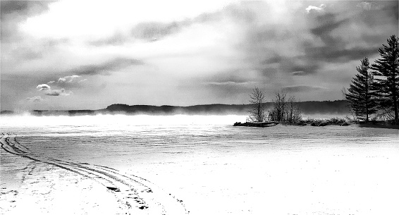 Long Lake located in Harrison, Maine.  A frosty windy morning on Long Lake with winding snow cat tracks.