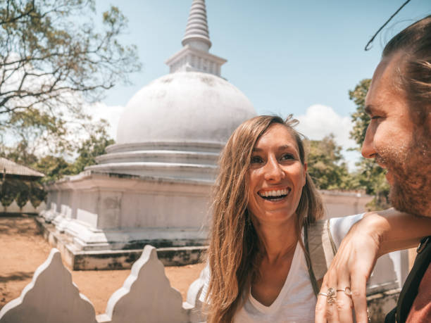 istock Couple contemplate white dome temple 1294888472