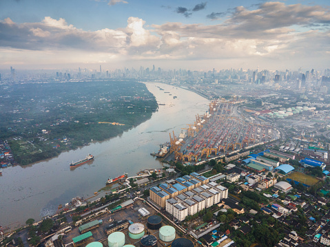 Aerial view of Chao praya river and bang kra chao at sunrise with industrial aera logistics shipyard and transportation zone in bangkok thailand