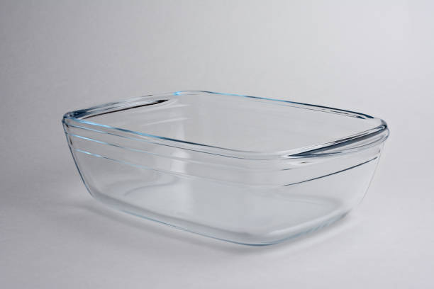 istock Empty glass baking tray, close-up on gray background with shadow 1294891480