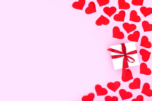 istock Background with gift and hearts with free space for text on pastel pink background. Flat lay, top view. Valentines day concept. Mother's Day concept. 1294893432