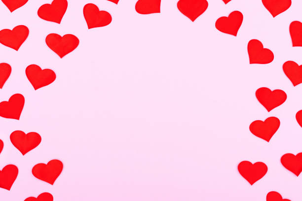 istock A card decorated with pattern red hearts, Valentine's Day. Celebration cards on pink background with copy space for your text. Banner. 1294893439