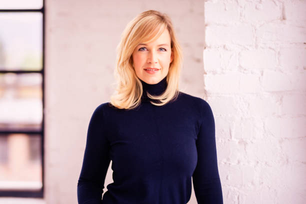 istock Attractive blond haired woman portrait while standing indoor 1294894055
