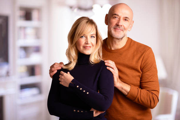 istock Smiling couple standing together at home 1294894095