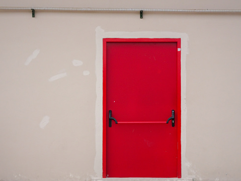 A red emergency exit on a building