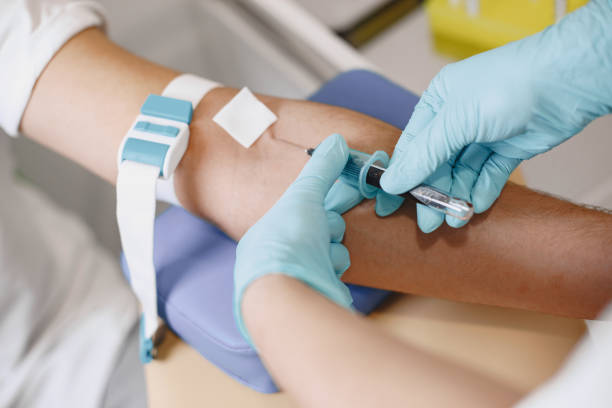 istock Nurse taking blood sample from patient at the doctors office 1294895598