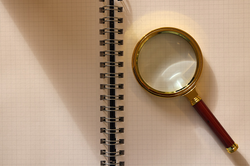 Magnifying Glass on Paper Background